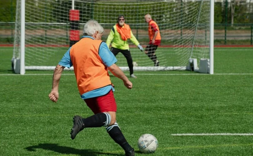 A group of people playing a game of soccer